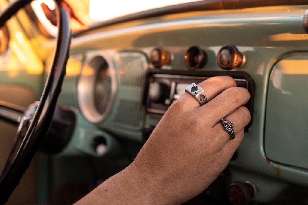Person turning on the car radio