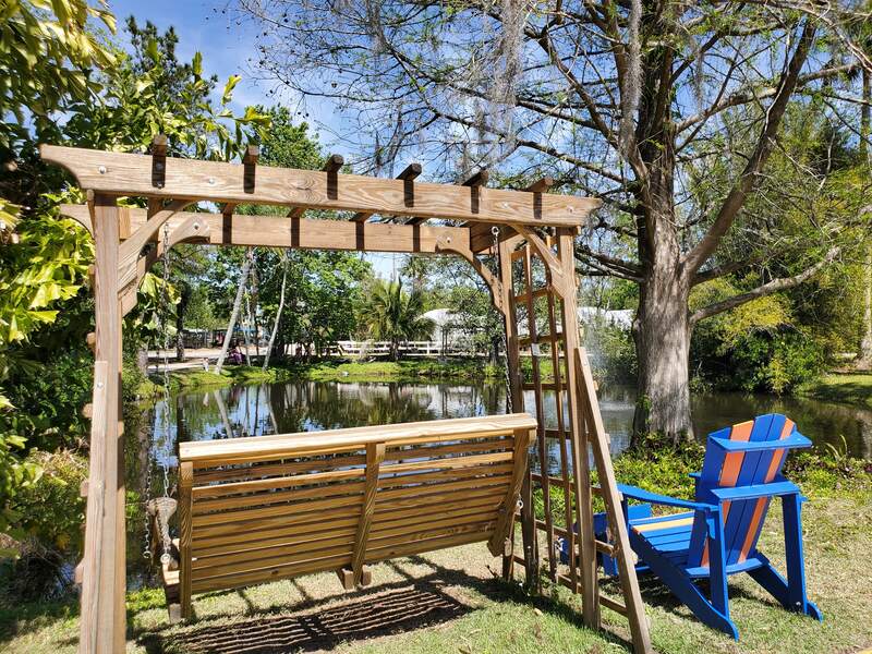 Porch swing and chair by the pond at Lukas Nursery in Oviedo, FL